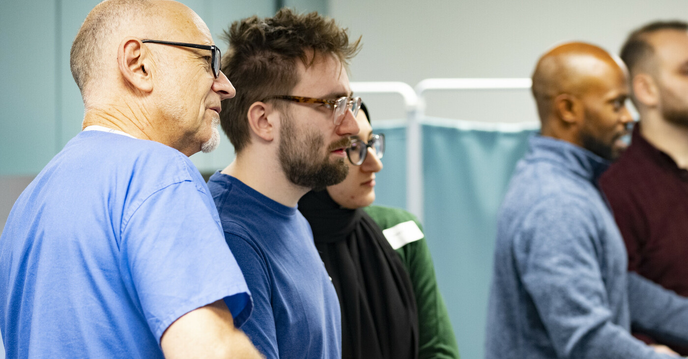 Group of delegates looking on at teaching off screen