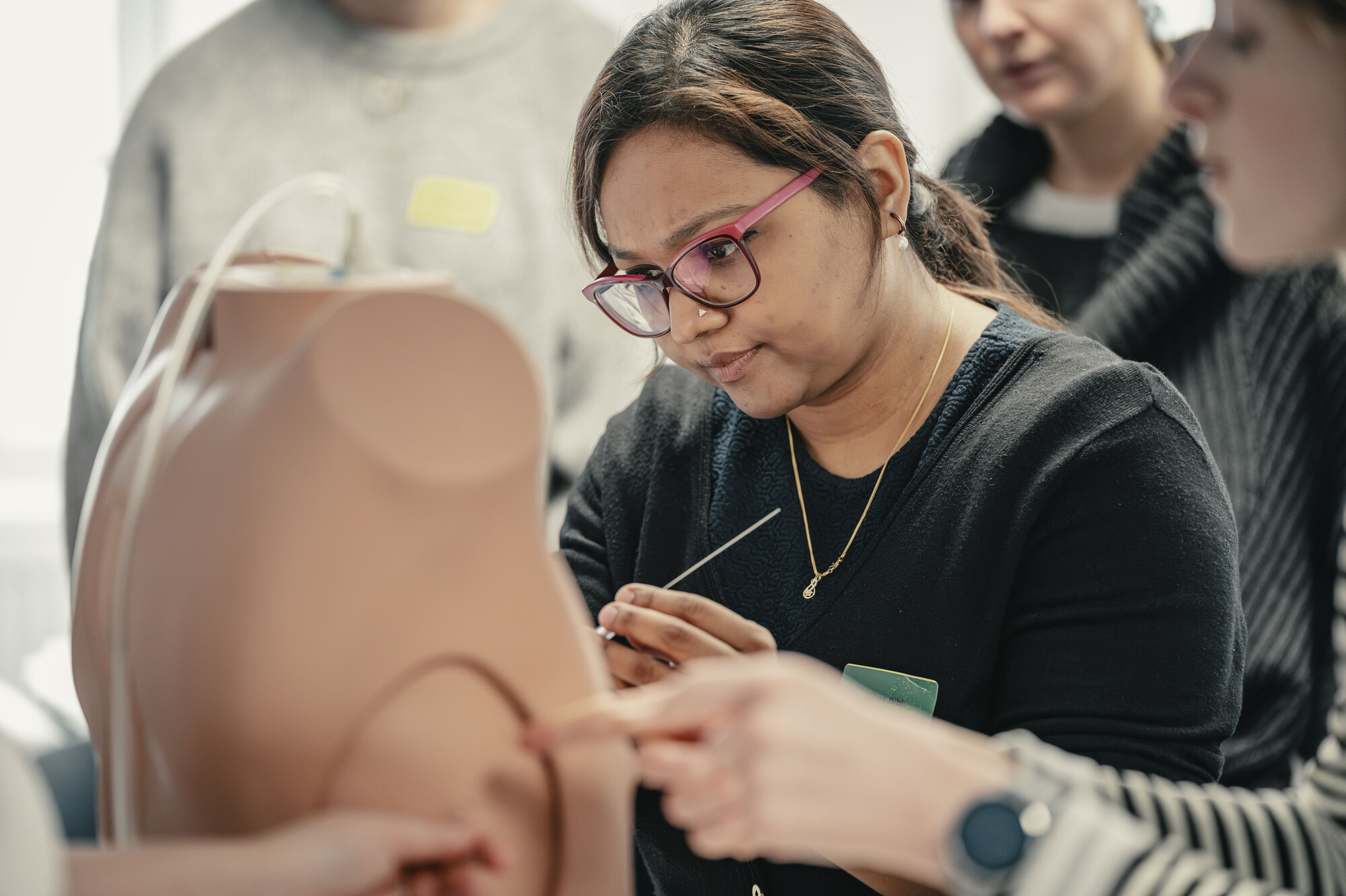 Participant looking at model in IMPACT course