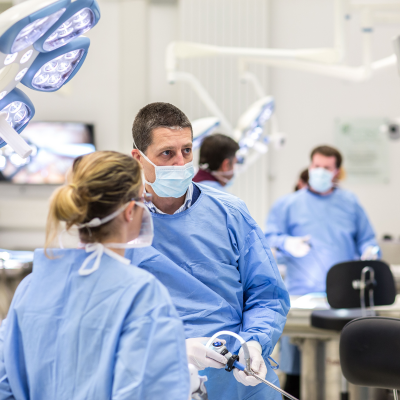 Two people in surgical dress working on a CASC course