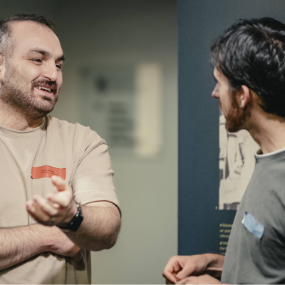 two men chatting and smiling