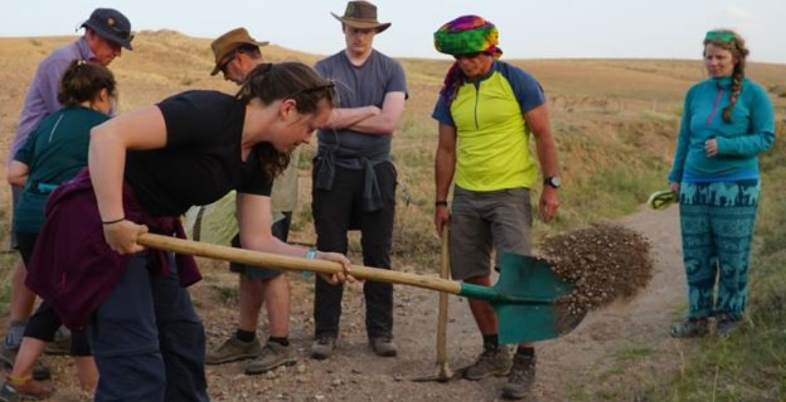 a woman digging with a shovel