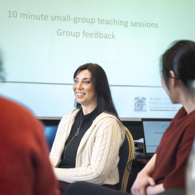 a woman smiling at at presentation