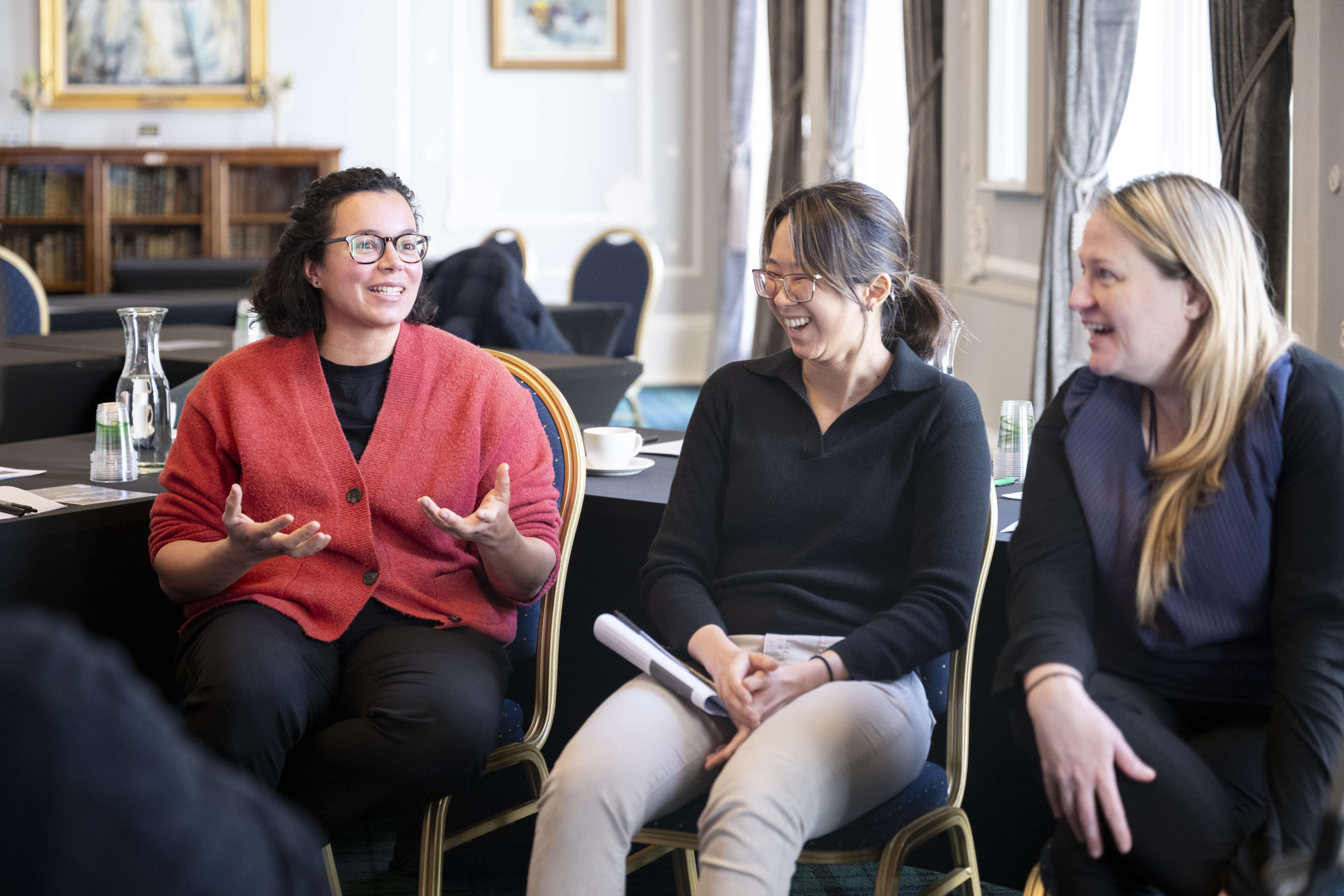 a group laughing and discussing