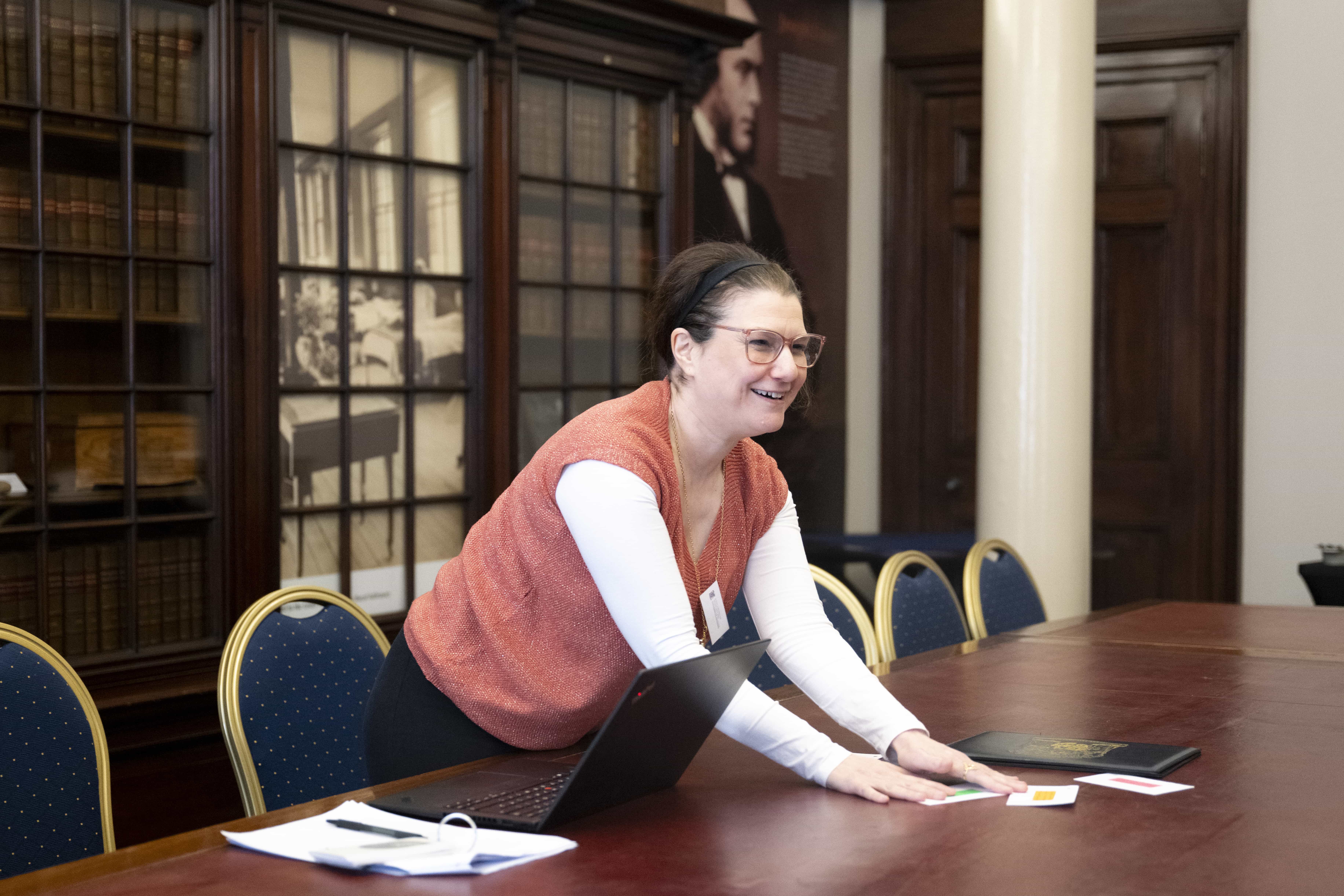 a woman using coloured cards in a group activity