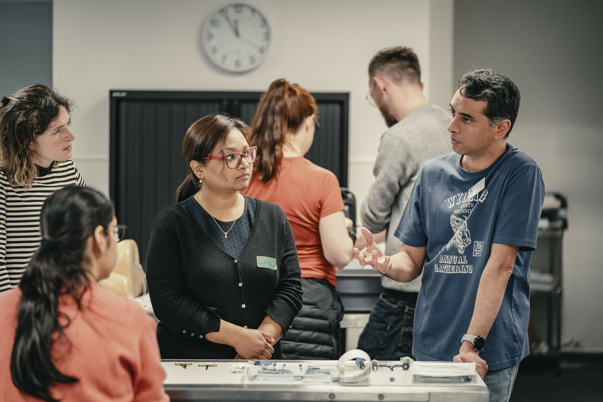 Man on right hand side teaching two people at practical skills course