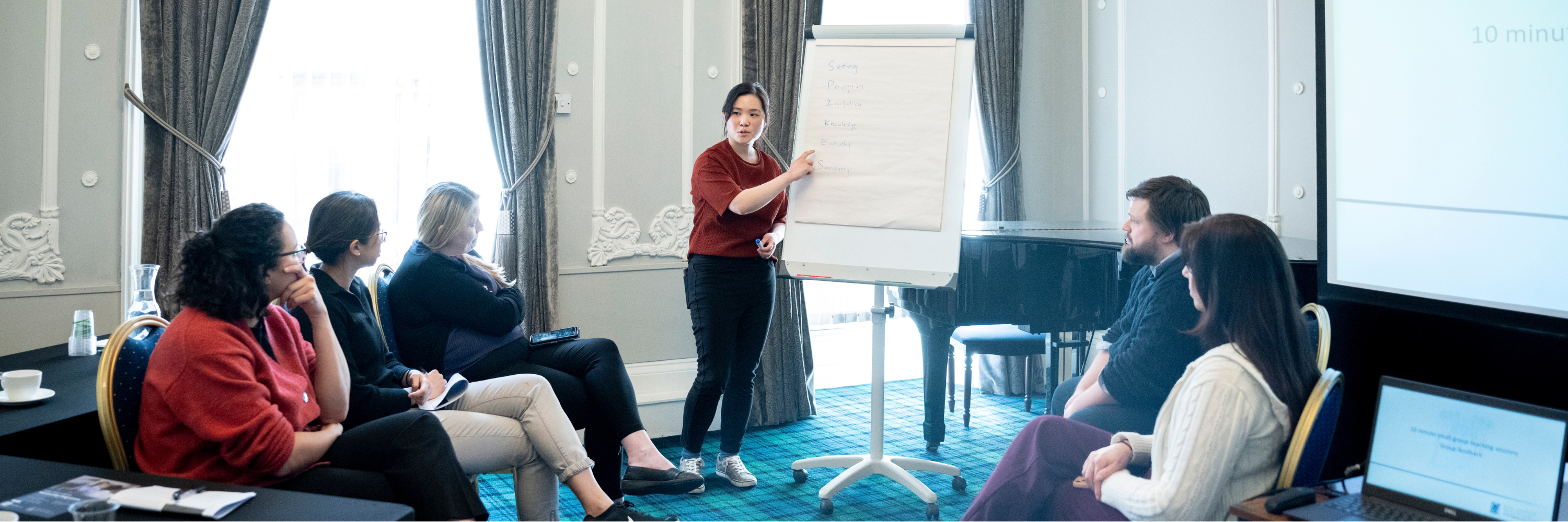 One person presenting to a group of people