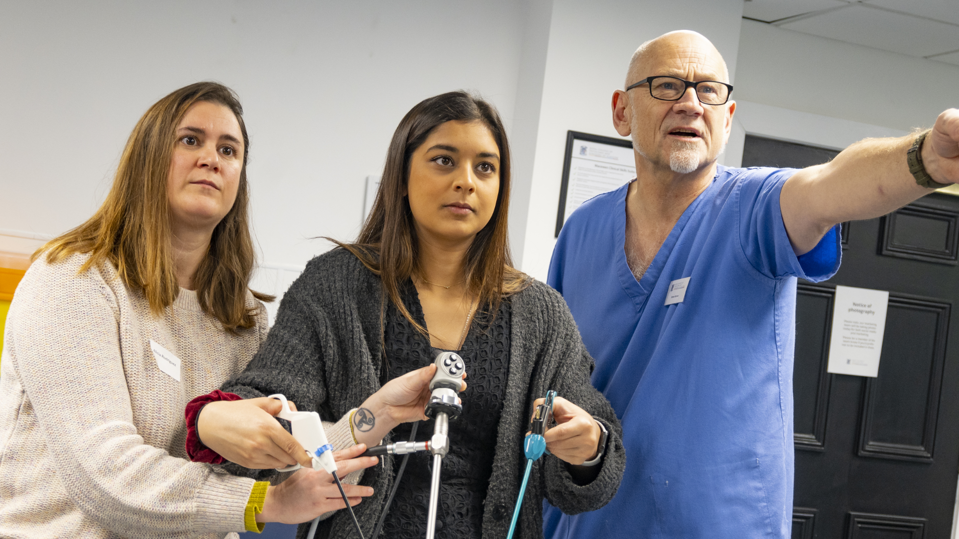 1 clinician and 2 participants doing practical learning