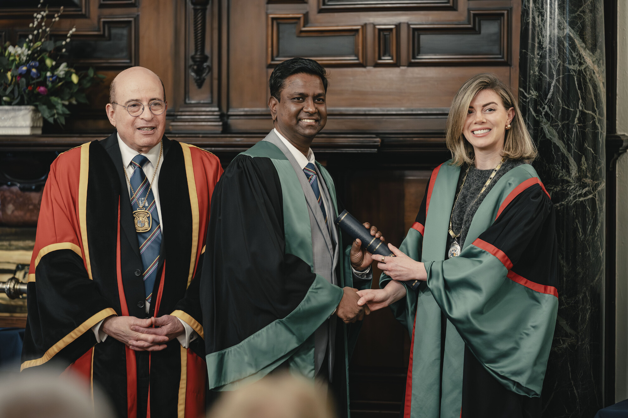 Picture of diplomate receiving their diploma